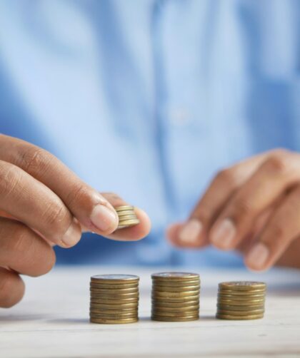 a person stacking coins on top of a table